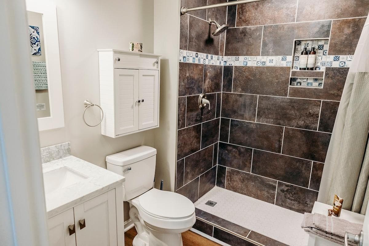 Perhaps my favorite feature of the latest renovation is the dark tile shower with Moroccan tile inset.  