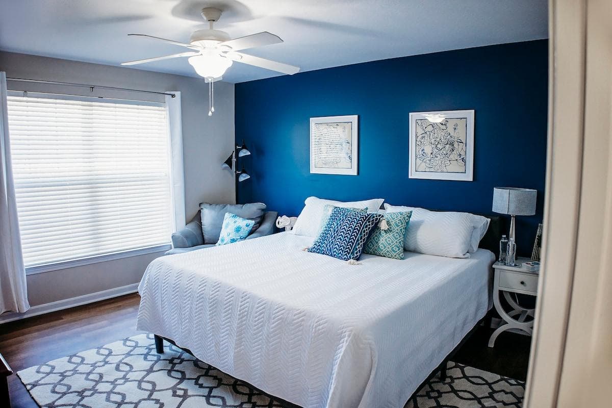 The large master suite includes a King bed, oversized leather lounge chair, and SmartTV, and a luxurious tile shower in the en suite bathroom!